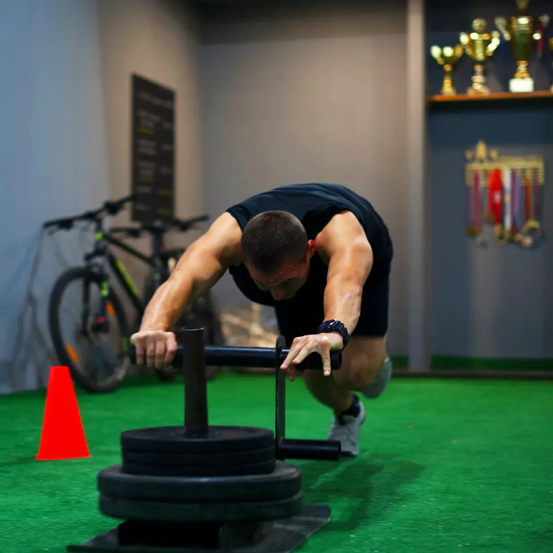A member pushing a sled in Superior Athlete Performance Center